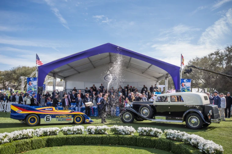 Champagne sprayed between a Can-Am Porsche and a Duesenberg town car at the Best in Show presentation at the Amelia Island Concours d’Elegance, an engagement in the season calendar of The Mansa Court