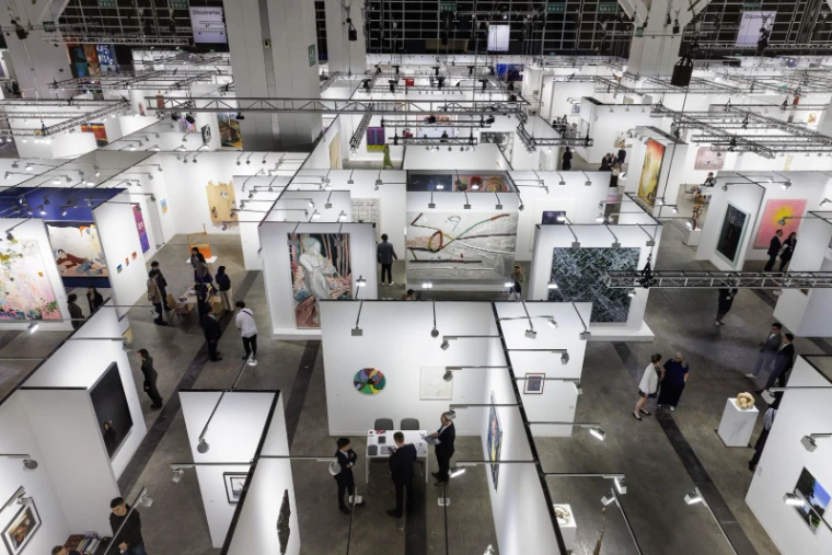 The fair floor and its grid of gallery booths seen from above at Art Basel Hong Kong, an engagement in the season calendar of The Mansa Court