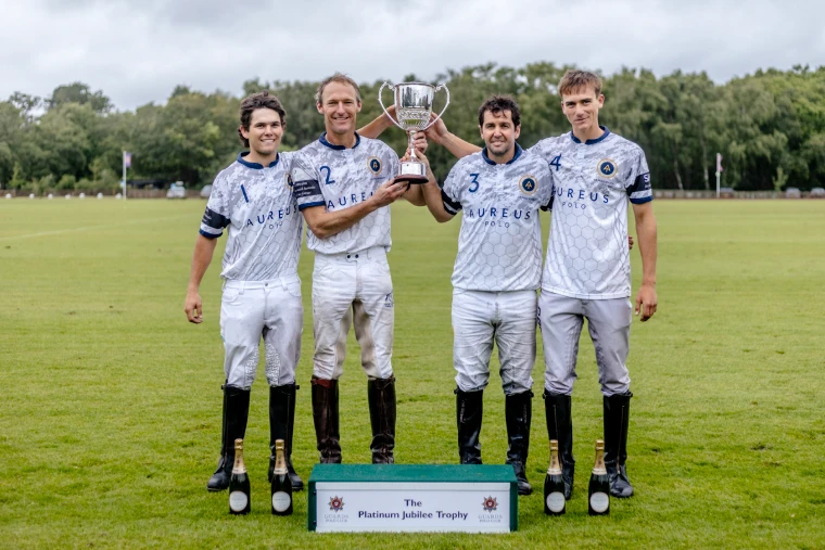 A team holds up the Platinum Jubilee Trophy on the field at Guards (2026). The Cartier Queen’s Cup at Guards Polo Club, Windsor Great Park, in the season calendar of The Mansa Court