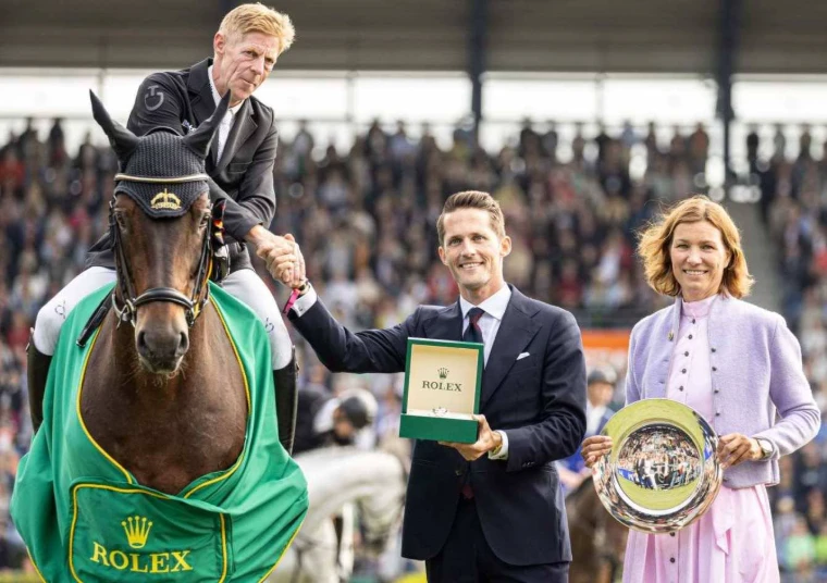 The Grand Prix winner on his horse in the green winner’s rug receiving the prize before the full stands at CHIO Aachen, an engagement in the season calendar of The Mansa Court