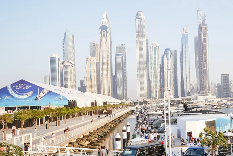 The show halls and berths along the waterfront below the towers of Dubai Marina at the Dubai International Boat Show, an engagement in the season calendar of The Mansa Court