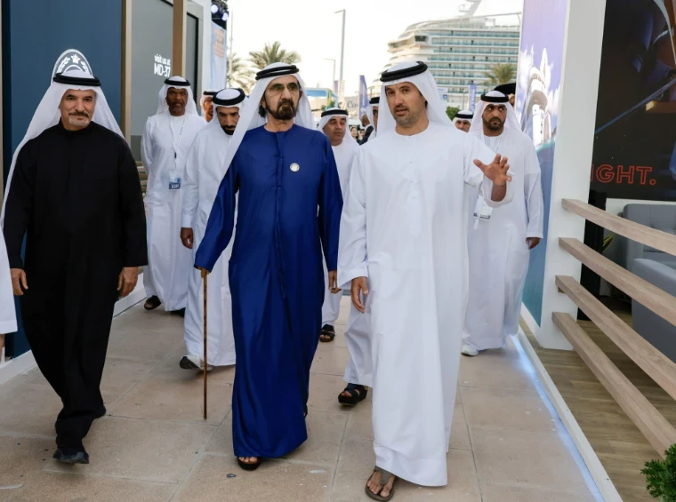An official party in Emirati dress touring the yacht berths with exhibitors at the Dubai International Boat Show, an engagement in the season calendar of The Mansa Court