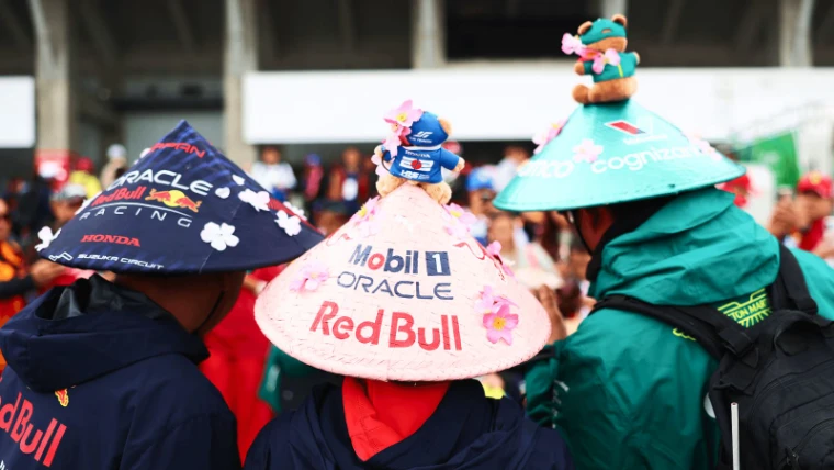 Japanese fans in team-painted straw hats trimmed with cherry blossom in the Suzuka grandstands at the Formula 1 Japanese Grand Prix, an engagement in the season calendar of The Mansa Court
