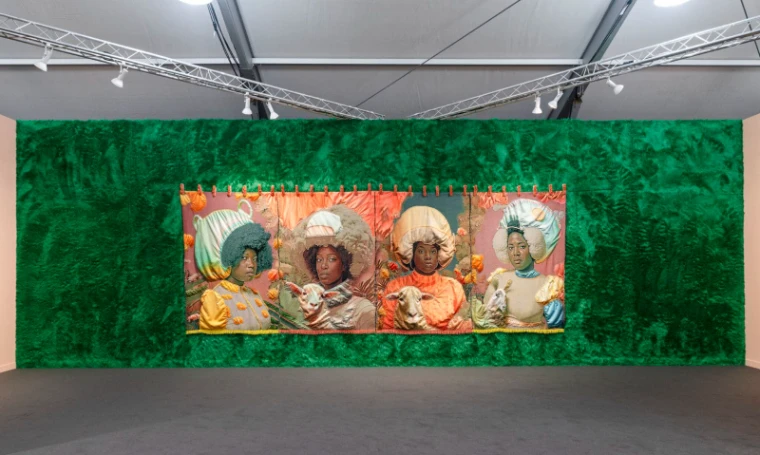 A four-panel textile work hung on a green fur wall in a gallery booth at Frieze Los Angeles, an engagement in the season calendar of The Mansa Court