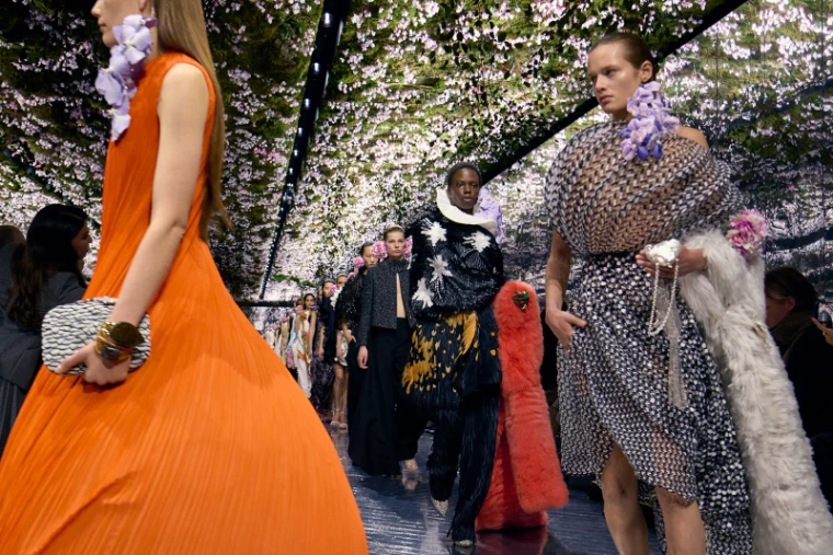 A flower-lined couture runway during Haute Couture Week in Paris, an engagement in the season calendar of The Mansa Court