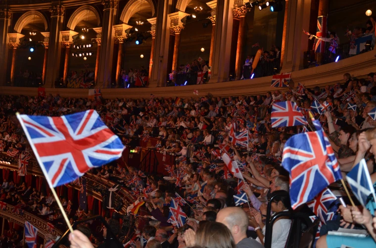 Union Flags and Saltires waved across the tiers of seats beneath the lit arches of the Royal Albert Hall (2014).