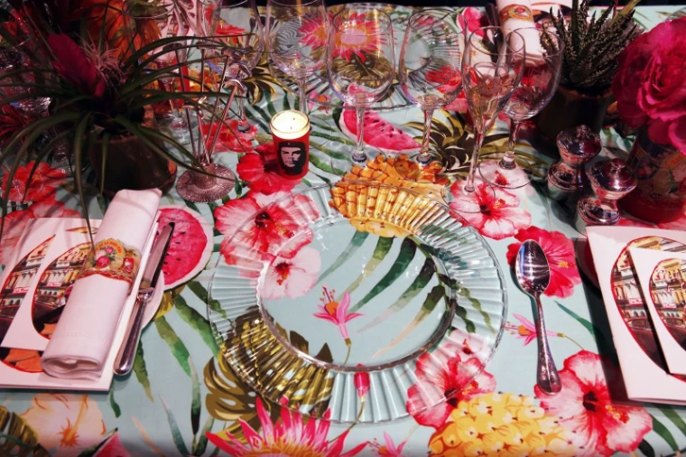 A place setting with printed menu card, floral cloth and candle at Le Bal de la Rose, Monte Carlo, an engagement in the season calendar of The Mansa Court