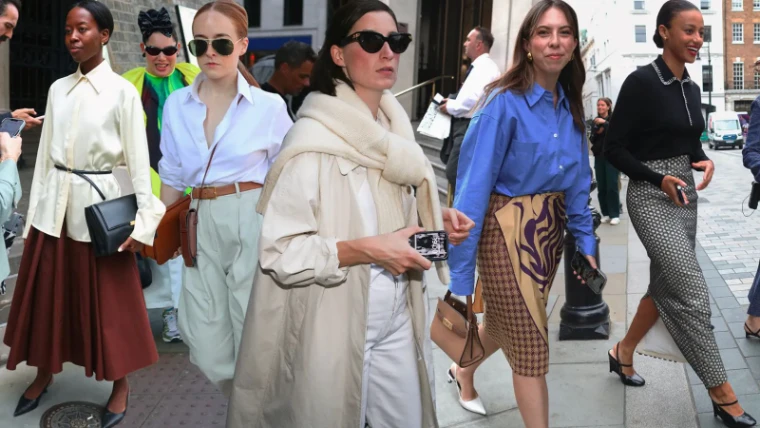 Guests photographed on the pavement between shows during London Fashion Week, an engagement in the season calendar of The Mansa Court
