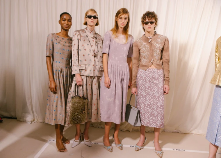 Models standing in look order behind the curtain backstage before a New York Fashion Week show, an engagement in the season calendar of The Mansa Court