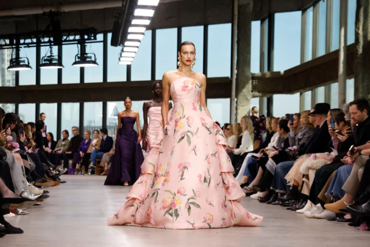 A floral silk evening gown on the runway of a glass-walled New York studio at New York Fashion Week, an engagement in the season calendar of The Mansa Court