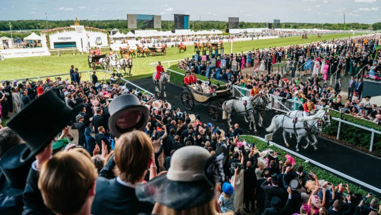 Horse-drawn landaus of the Royal Procession coming down the course at Royal Ascot, an engagement in the season calendar of The Mansa Court
