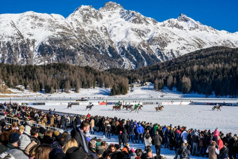 The frozen lake at St. Moritz with the Snow Polo World Cup field built on the ice and the mountains behind, an engagement in the season calendar of The Mansa Court