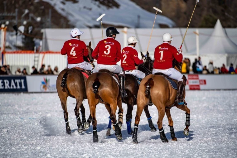 A team riding out onto the snow field at the Snow Polo World Cup, St. Moritz, an engagement in the season calendar of The Mansa Court