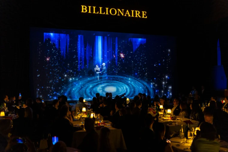 Singers performing before a candlelit room of dining tables at the Grand Gourmet closing show of the St. Moritz Gourmet Festival, an engagement in the season calendar of The Mansa Court