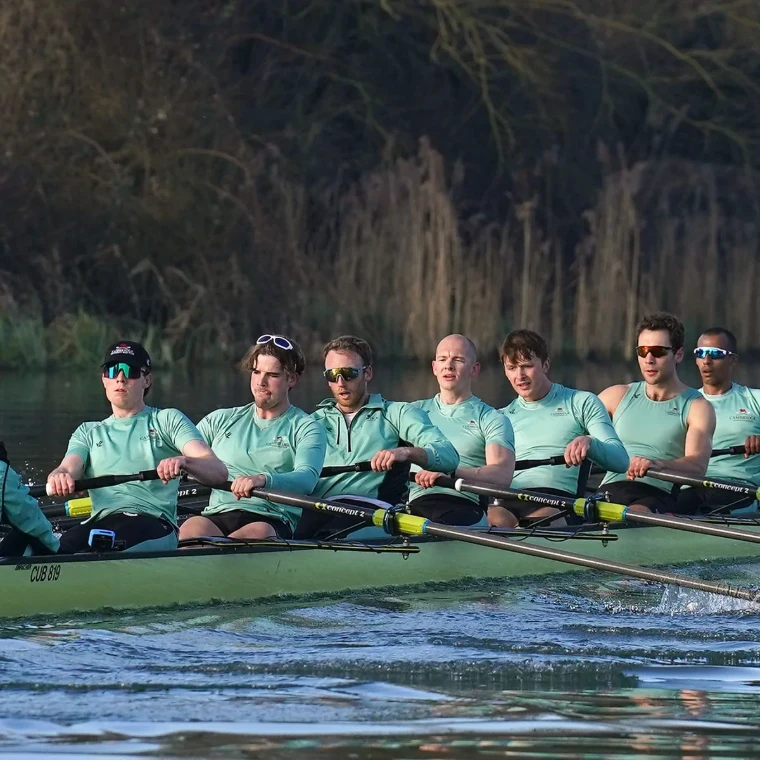 A light blue eight at full stroke on the Thames in training before The Boat Race, the Oxford and Cambridge fixture in London, a spring engagement in the season calendar of The Mansa Court