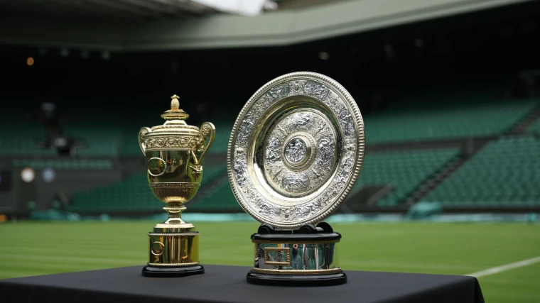 The gentlemen’s singles trophy and the Venus Rosewater Dish on display on Centre Court at The Championships, Wimbledon, London, the July tournament in the season calendar of The Mansa Court