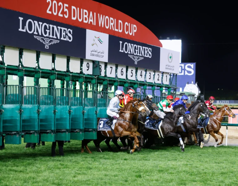 Runners breaking from the Longines stalls beneath the Dubai World Cup sign at Meydan, an engagement in the season calendar of The Mansa Court