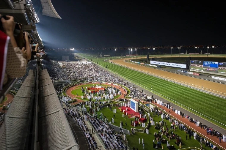The parade ring and the crowd beneath the Meydan grandstand on Dubai World Cup night, the closing meeting of the Dubai Carnival in the season calendar of The Mansa Court