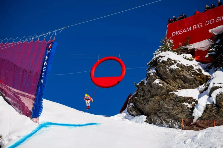 A racer in the air off the Hundschopf jump on the Lauberhorn course above Wengen, an engagement in the season calendar of The Mansa Court