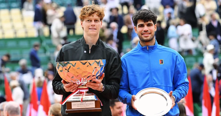 Jannik Sinner holding the champion’s trophy beside runner-up Carlos Alcaraz at the 2026 Rolex Monte-Carlo Masters presentation, Monte Carlo, an April engagement in the season calendar of The Mansa Court