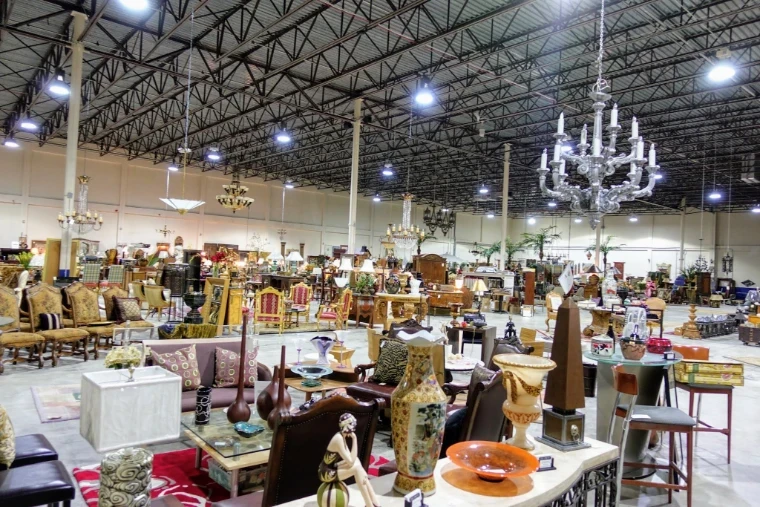 A long showroom floor of antique furniture, porcelain vases and hanging chandeliers, the trade behind The Palm Beach Show, West Palm Beach, an engagement in the season calendar of The Mansa Court