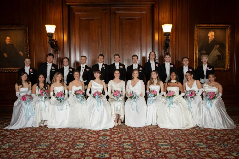 The debutantes in white gowns and their escorts in white tie, seated for the portrait at the Piarist Debutante Ball, The University Club, New York, an engagement in the season calendar of The Mansa Court