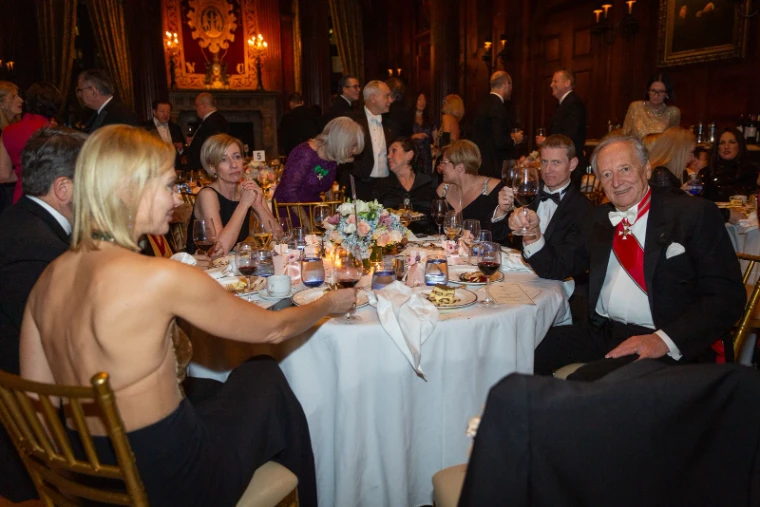Dinner by candlelight in the panelled hall of The University Club, New York, at the Piarist Debutante Ball, an engagement in the season calendar of The Mansa Court
