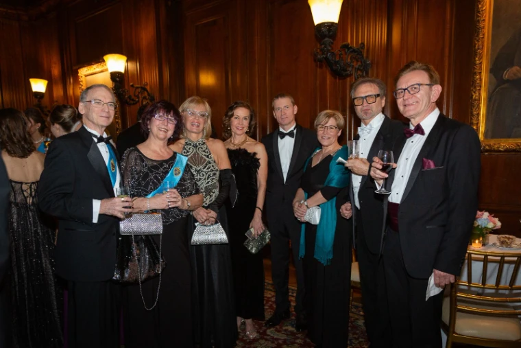Guests in evening dress at the reception of the Piarist Debutante Ball, The University Club, New York, an engagement in the season calendar of The Mansa Court