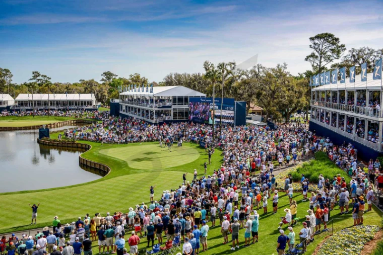 The island green seventeenth ringed by grandstands and hospitality pavilions at The Players Championship, TPC Sawgrass, an engagement in the season calendar of The Mansa Court