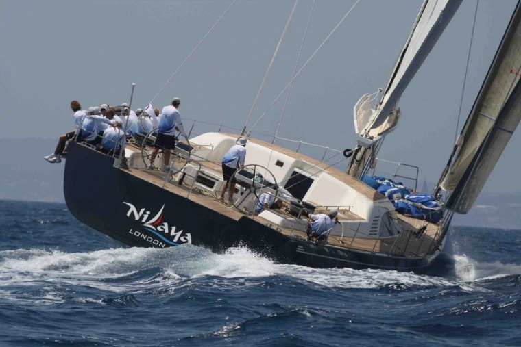 A superyacht heeling on the beat with her crew sitting out on the rail at The Superyacht Challenge, English Harbour, an engagement in the season calendar of The Mansa Court