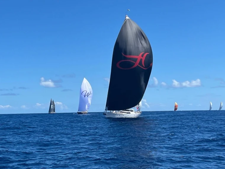 Superyachts running downwind under spinnaker in open Caribbean water at The Superyacht Challenge, English Harbour, an engagement in the season calendar of The Mansa Court