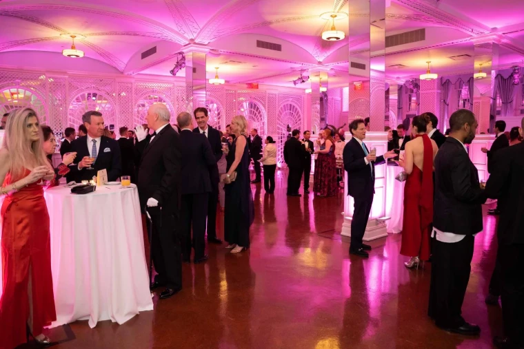 Guests in black tie and evening gowns at the drinks reception before The Swiss Ball in New York, an engagement in the season calendar of The Mansa Court