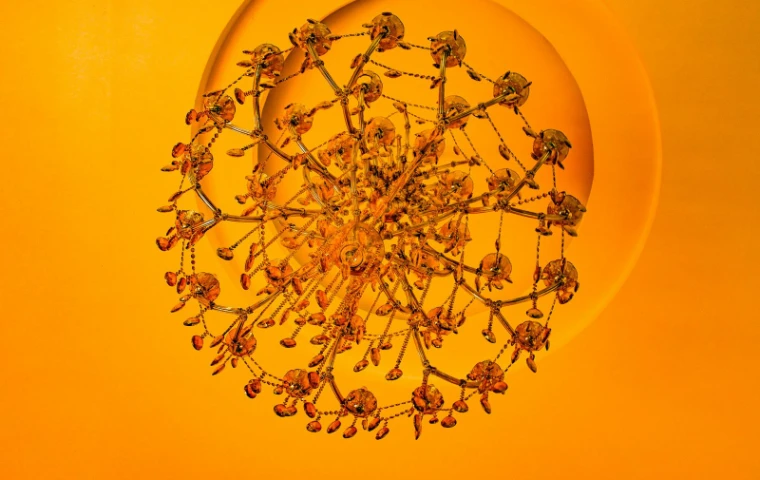 A crystal chandelier seen from directly below against a ceiling washed in amber light, for The Vernal Ball, New York, late April in the season calendar of The Mansa Court