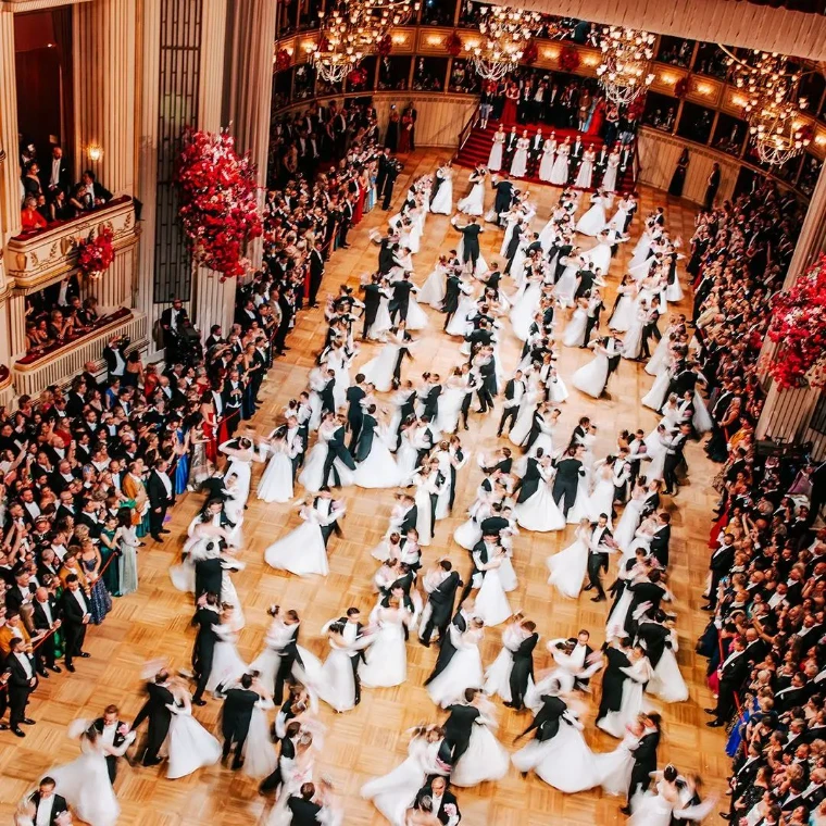 The opening waltz at a Vienna ball, white gowns and black tails turning together, at The Vienna Ball Season, an engagement in the season calendar of The Mansa Court