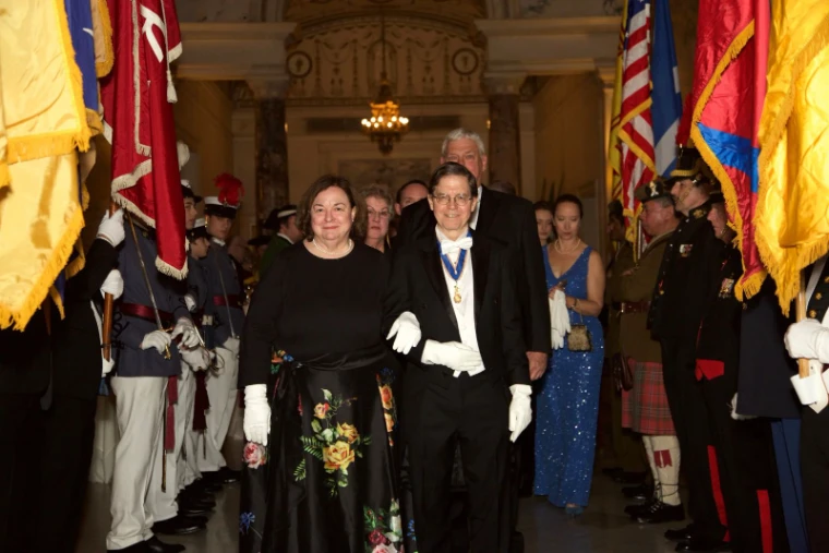Guests in white tie processing between a colour guard of standards at The Washington Birthday Ball, New York, an engagement in the season calendar of The Mansa Court