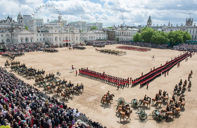 The Foot Guards drawn up in line on Horse Guards Parade, the King’s Troop and the Household Cavalry wheeling before the stands. Trooping the Colour on Horse Guards Parade, London, in the season calendar of The Mansa Court