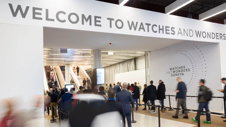 Visitors passing beneath the welcome sign at the entrance to the fair at Watches and Wonders Geneva, an early-April engagement in the season calendar of The Mansa Court